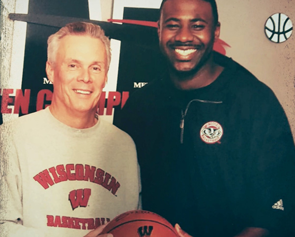 Bo Ryan and Howard Moore wearing UW Wisconsin apparel holding a basketball