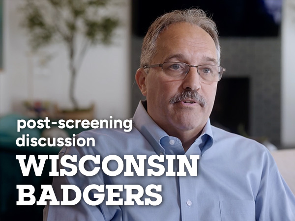 Stan Van Gundy speaking in A Road at Night movie still and word overlay "post screening discussion WISCONSIN BADGERS"